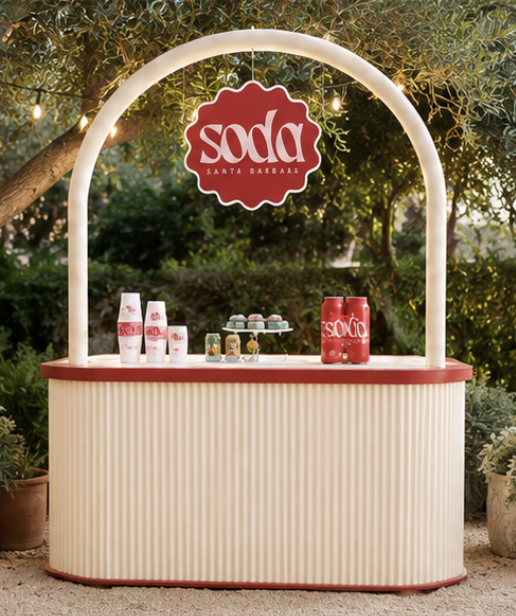 Fluted cream and red pop-up soda bar in a garden setting